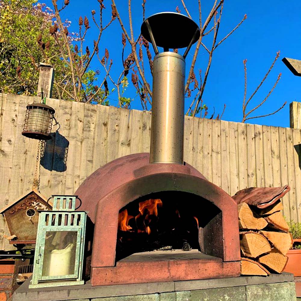 Igneus Ceramiko 600 Wood Fired Pizza Oven — styled in a garden setting