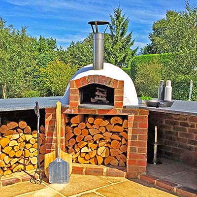 Igneus Ceramiko 760 Wood Fired Pizza Oven — in a patio setting