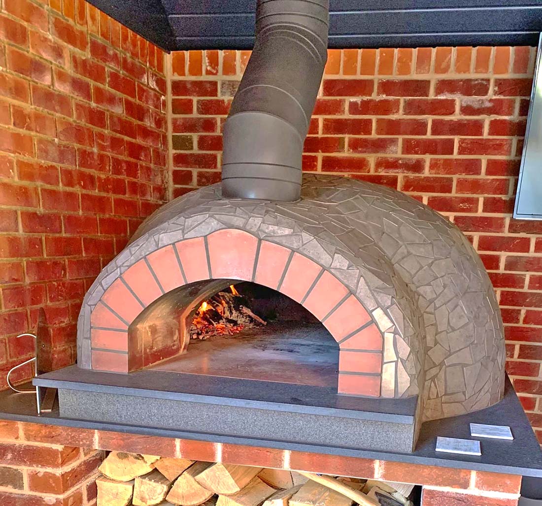 Igneus Ceramiko Pro 1000 Wood Fired Pizza Oven — styled in a garden setting