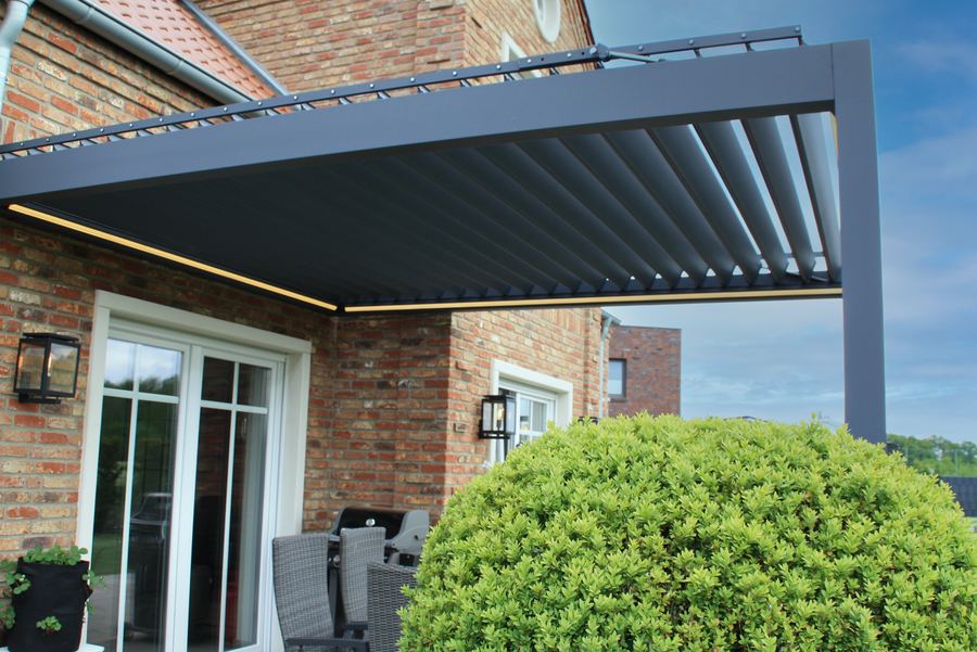 Portico pergola in white at dusk with louvres closed and LED lighting below