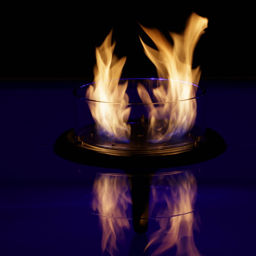 GlammFire Flut Floating Burner — styled in a garden setting